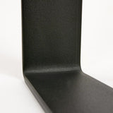 Inside bend of metal coffee table legs in black powder coat