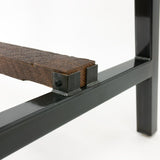 Back side of wood support bracket on steel table base